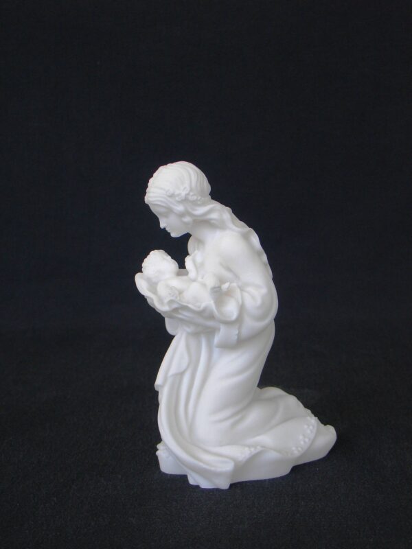 The statue of Mary holding the baby Jesus in her arms in White color