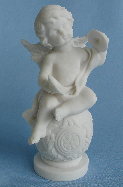 A statue of an Angel playing cymbals sitting on a sphere in White color