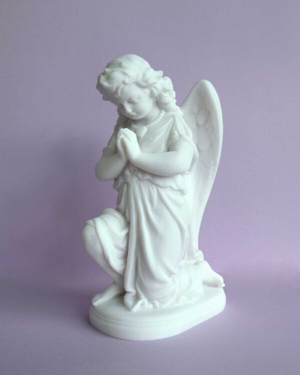 The statue of an Angel praying on its knee in White color