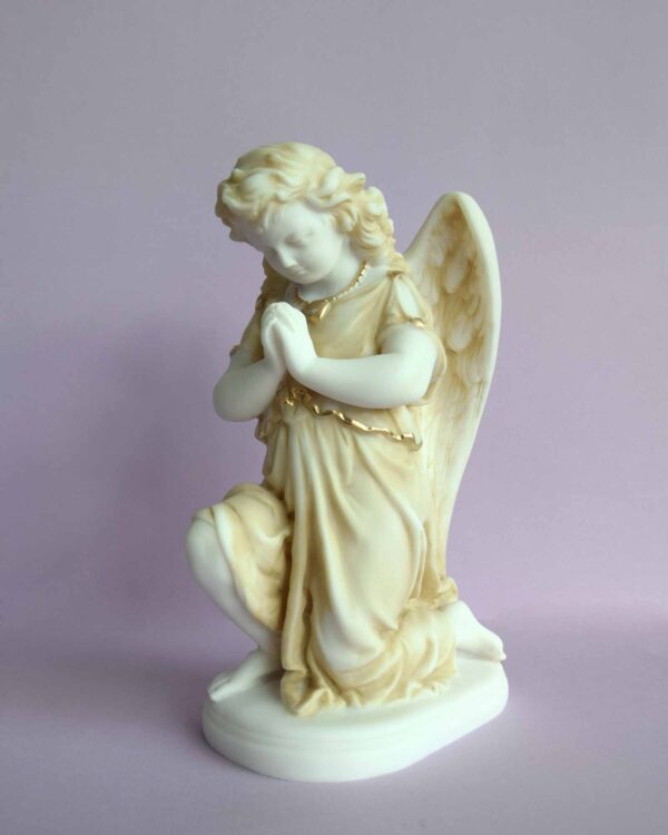 The statue of an Angel praying on its knee in Patina color