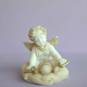 A statue of an Angel riding the bike in Patina color