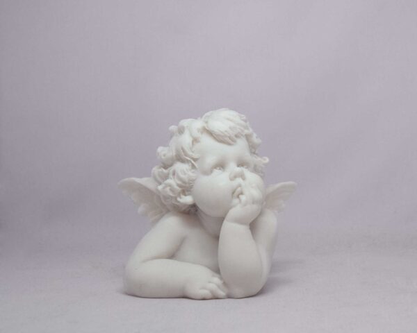 The statue of a little Angel thinking in White color