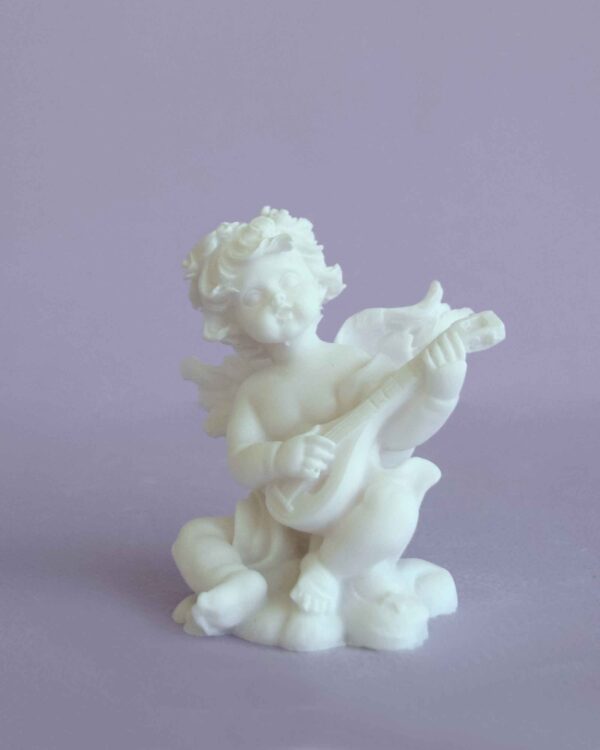 A statue of an Angel playing his mandolin in White color