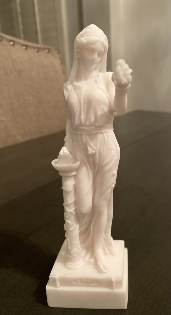 The statue of Hestia standing close to fire in White color