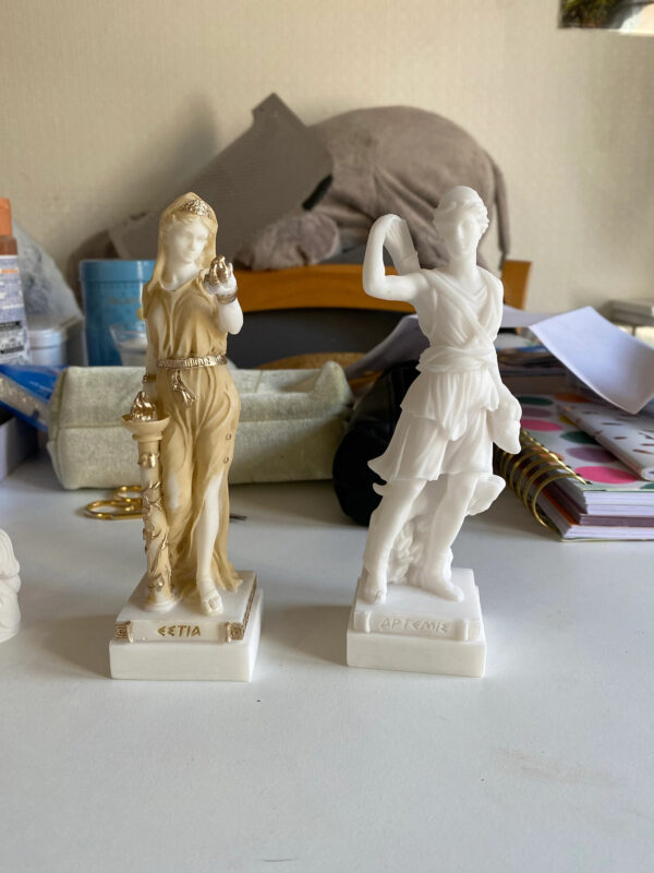 The statue of Hestia standing close to fire and Artemis statue Greek Goddess made of Alabaster